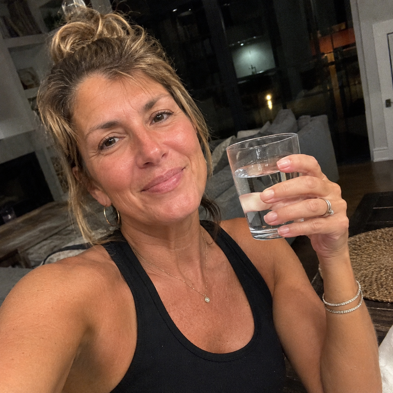 Nora C. with a glass of OnTime Water at home.